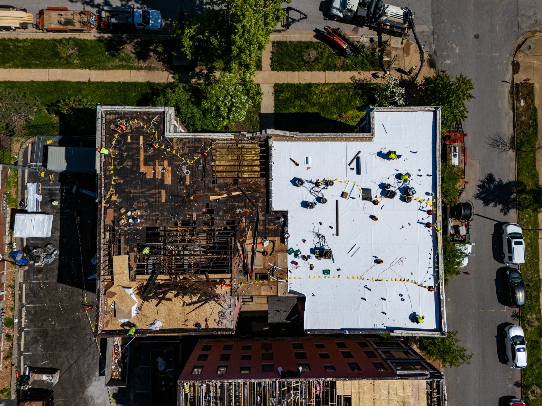 Top-down view of active commercial roofing work for Gringo Roofing