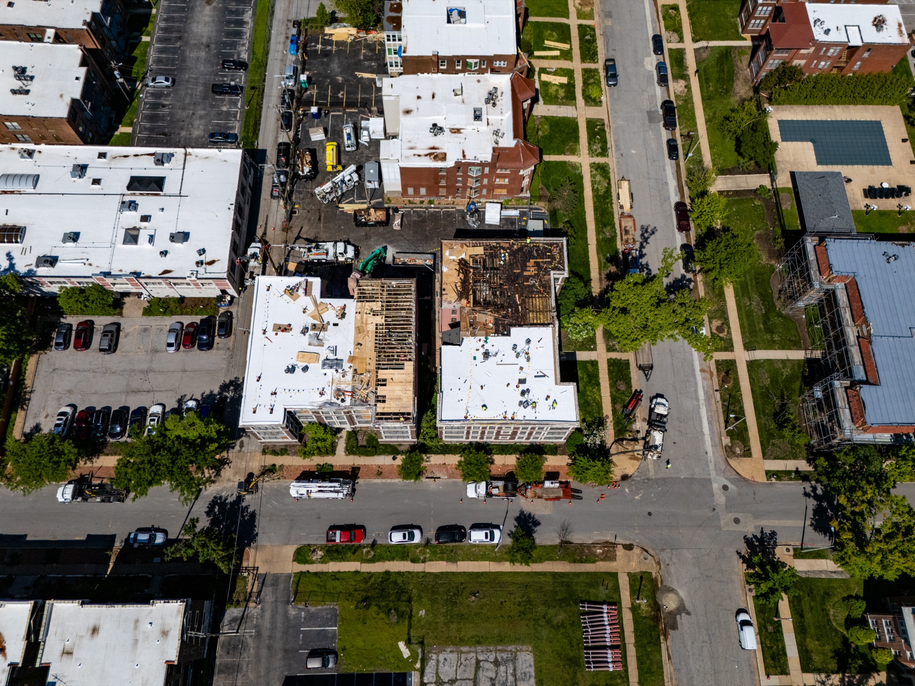 Top-down aerial of the new white roof membrane and active work areas